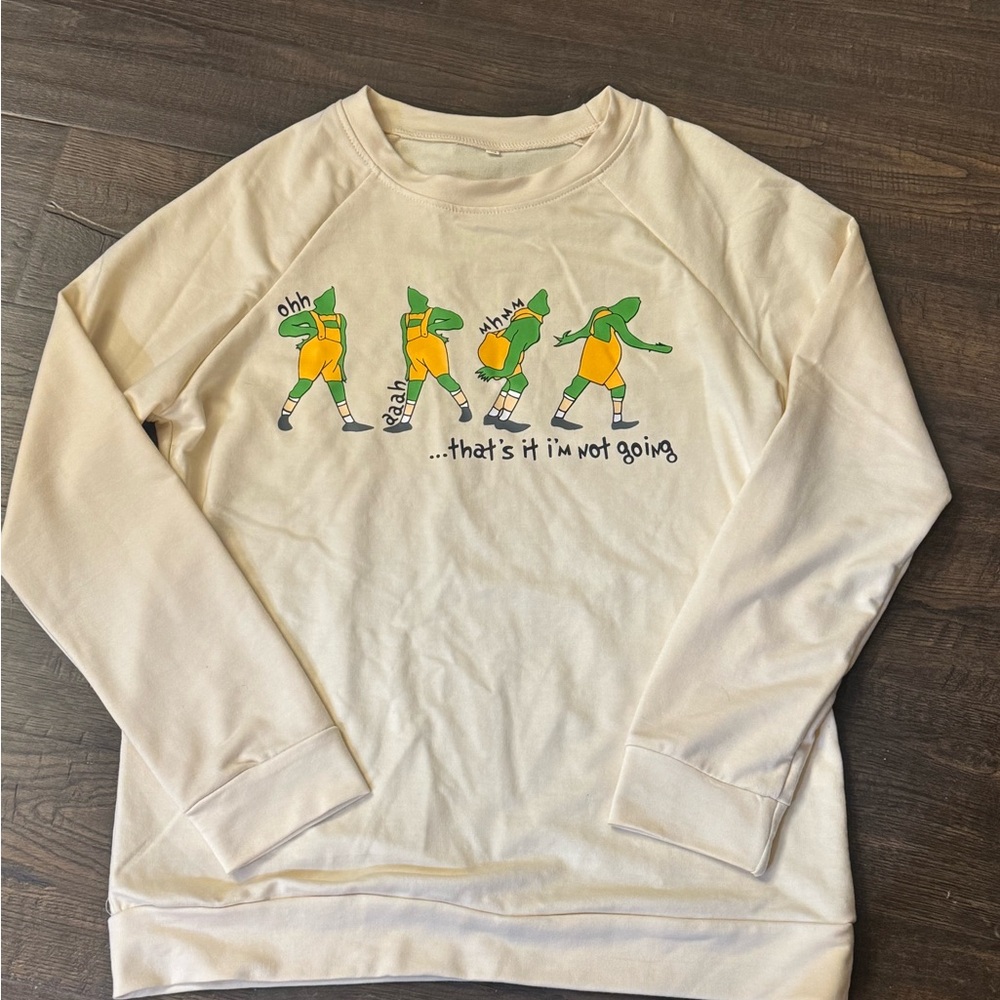 Cream colored women’s grinch sweatshirt size medium
